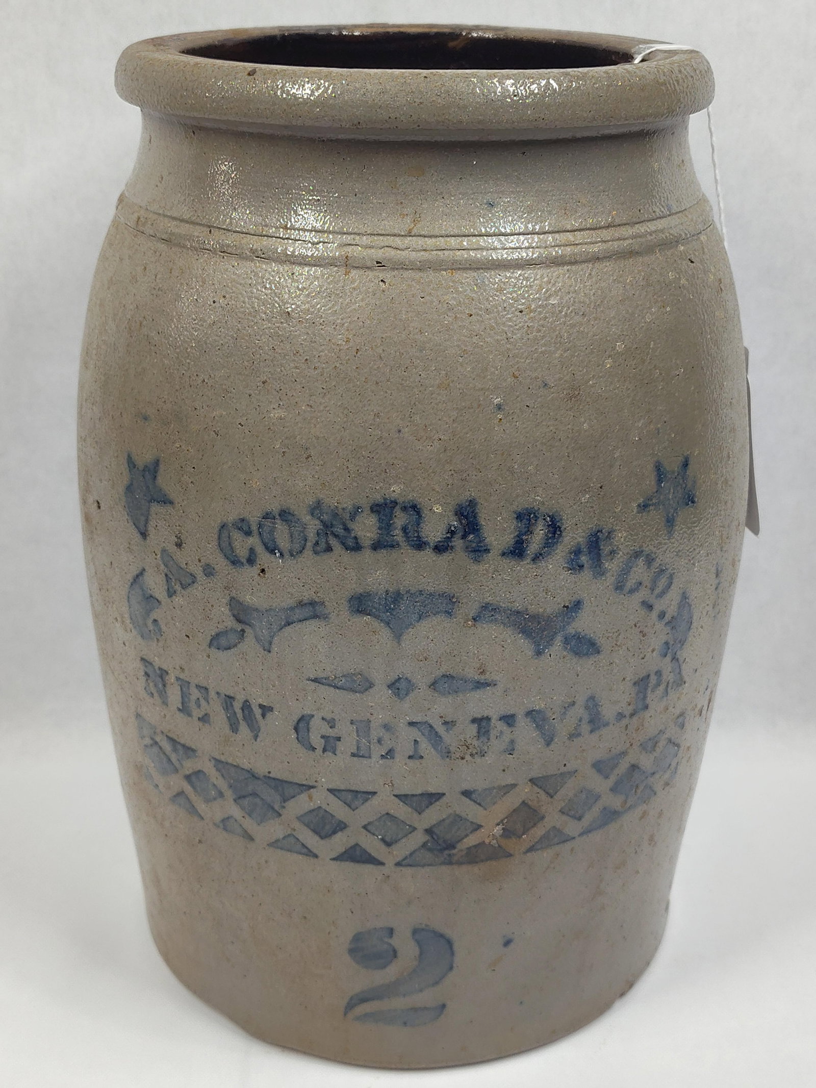 A. Conrad & Co Decorated 2gal Stoneware Jar: New Geneva, PA. Shows a few chips on base otherwise appears to be good. 12in tall.