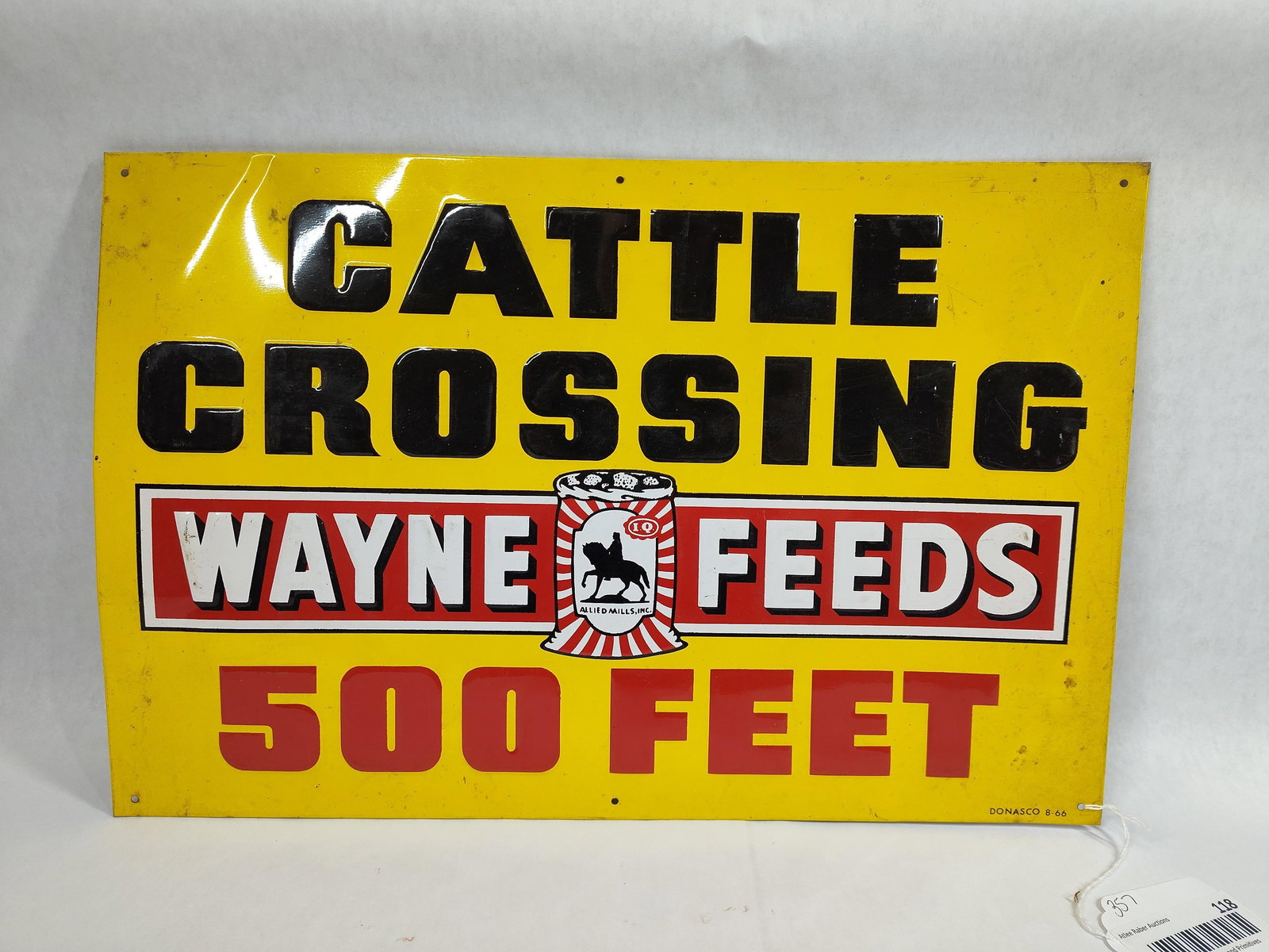SST Wayne Feeds Cattle Crossing embossed sign: 1-sided painted metal embossed sign with minor scuffing and a few minor wrinkles but overall is good with great gloss!! Marked Donasco 8-66. 11.5in x 17.5in.