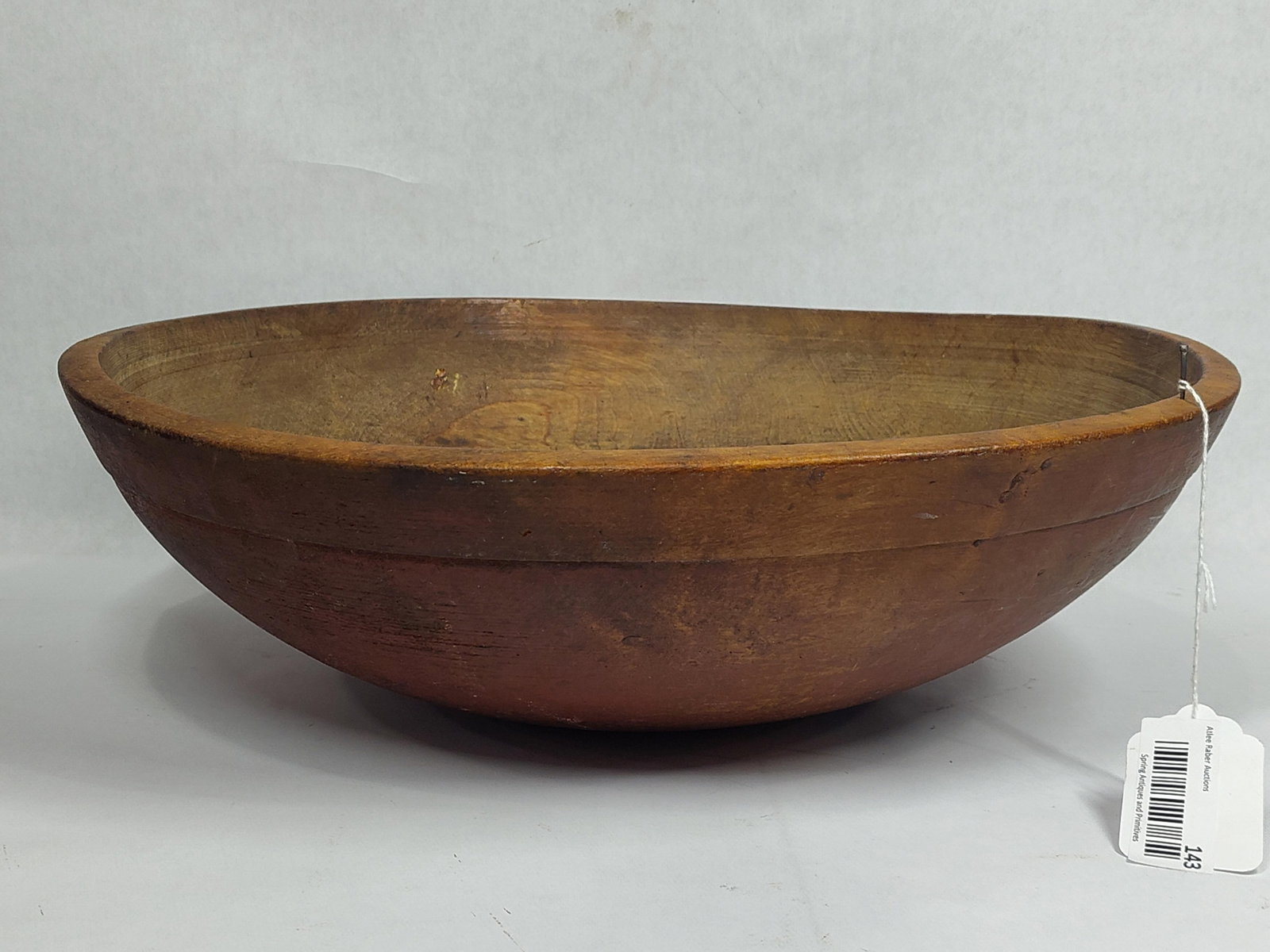 Primitive red painted wooden butter bowl: Does have a crack in bottom. Approximately 16in to 17in diameter.