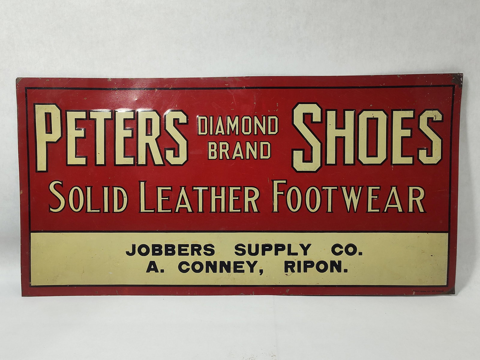 SST Peters Diamond Brand Shoes sign: 1-sided painted metal sign with minor scuffing and edge wear, overall is good. TAC authenticated. Marked Stout Sign Co. 11.75in x 23.25in.