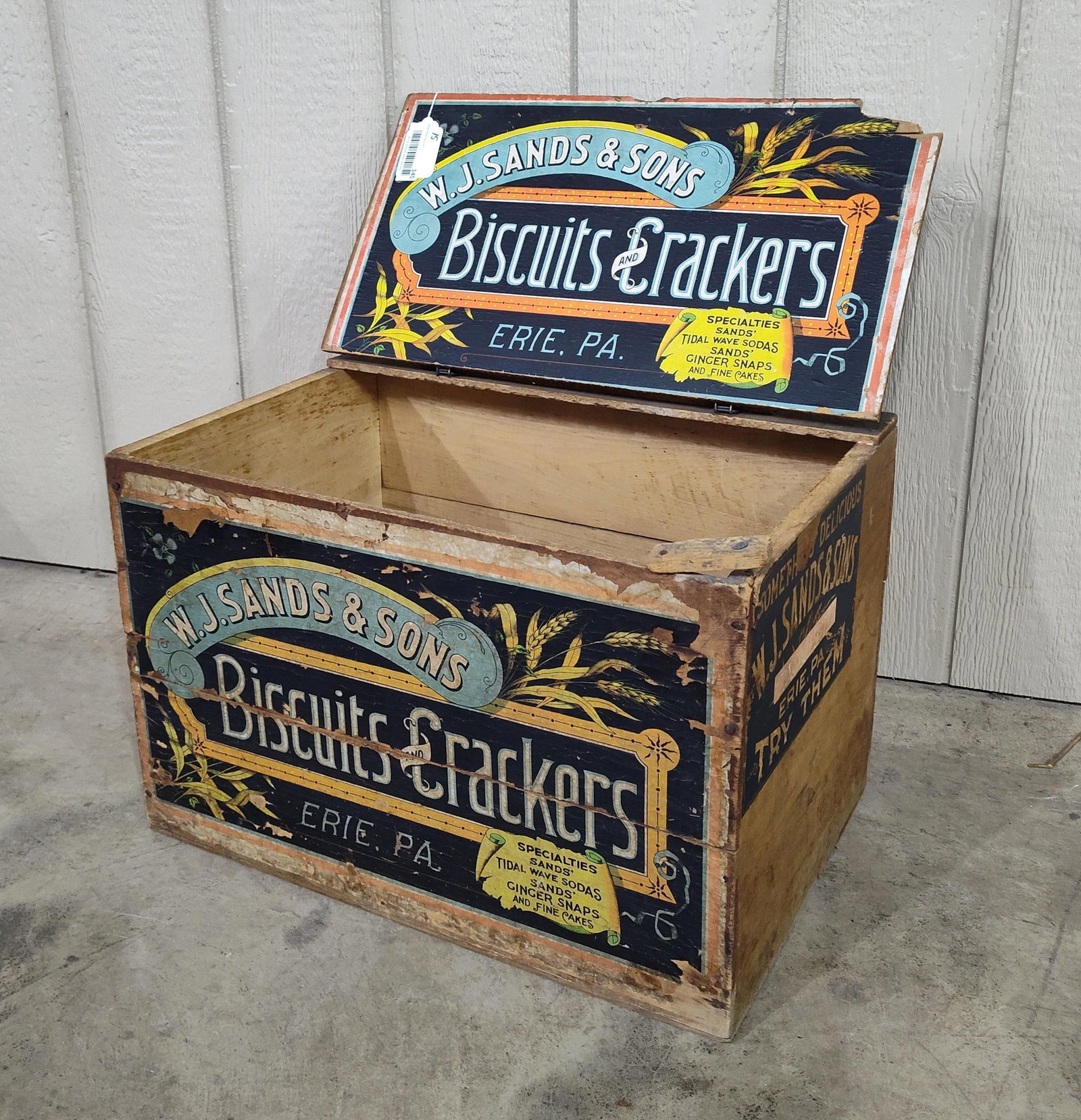 W.J. Sands & Sons Biscuits and Crackers box: Does have a break in front right corner of lid. With wire hinged lid and original label on front. 21.5in long 14in wide 14.5in tall.