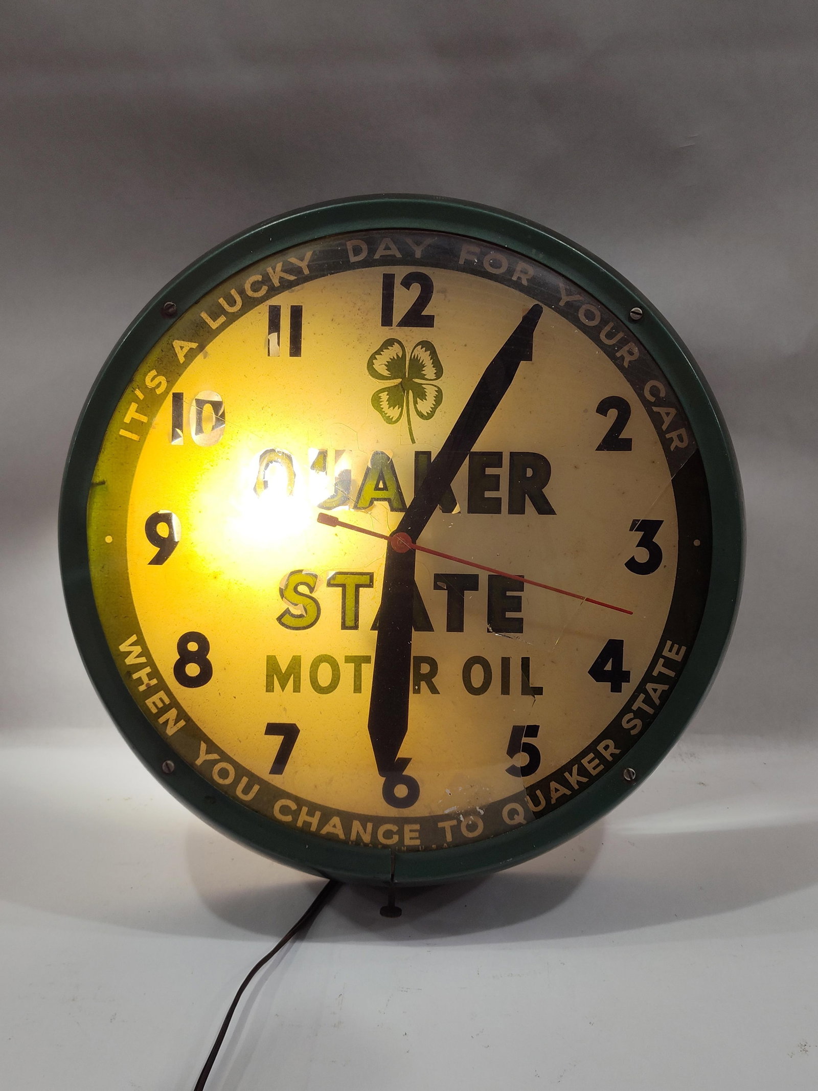Quaker State Motor Oil Dualite Lighted Clock: Appears hands have been replaced, otherwise is all original with reverse painted glass dial, which shows some peeling and glass cover is broke. Just one side has a bulb, lights and runs as it should!