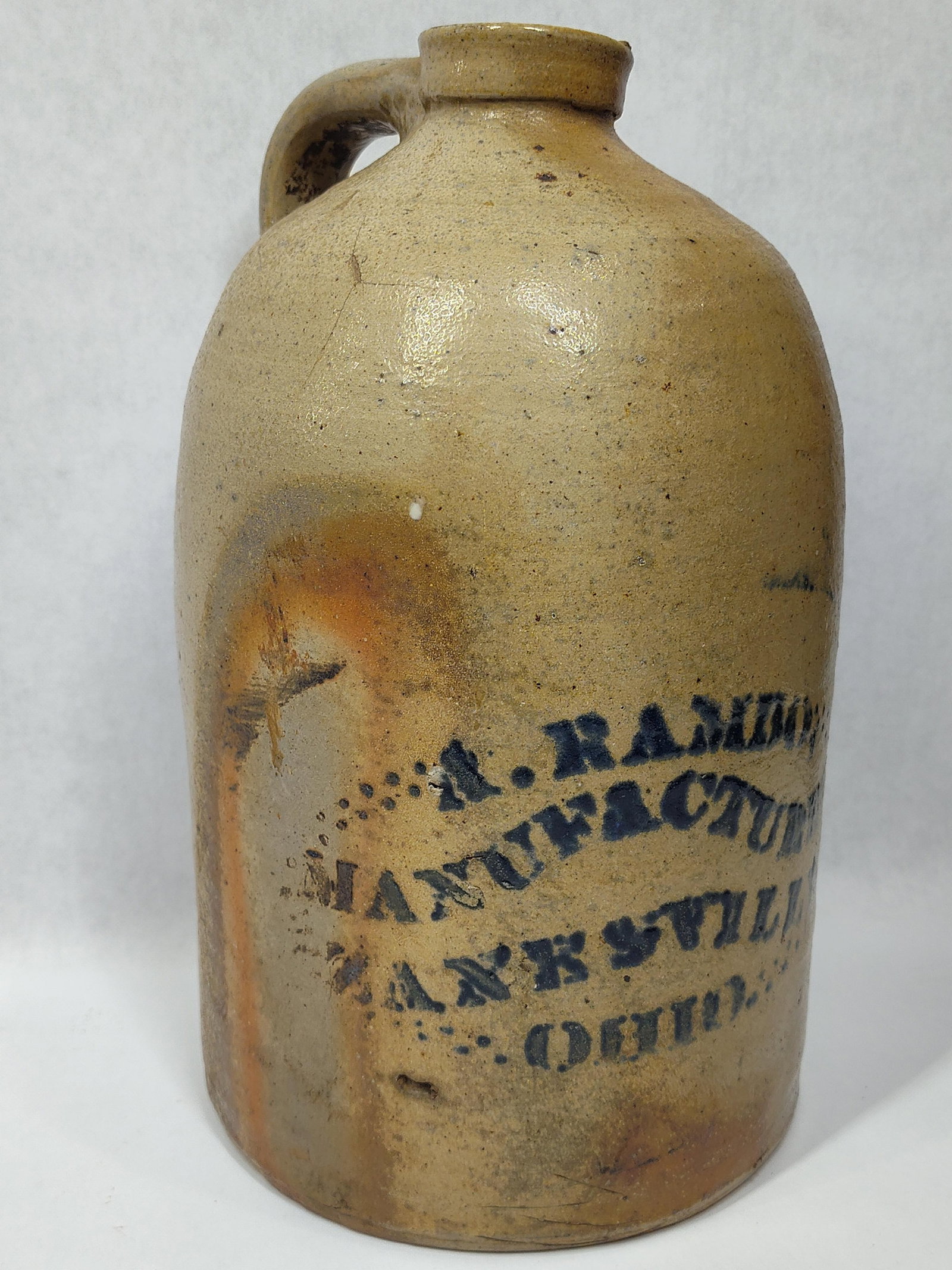 Rare A. Rambo Zanesville, OH 1gal Stoneware Jug: Shows minor hairlines on shoulder and a chip on rim, also shows some discoloration kiln marks but is a Rare Zanesville, Ohio piece! (Hairline is minor.) 11.5in tall.