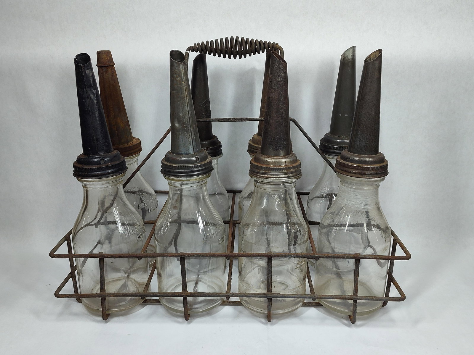 8-Glass Oil Bottles with carrier: 6 are identical, other 2 are same.