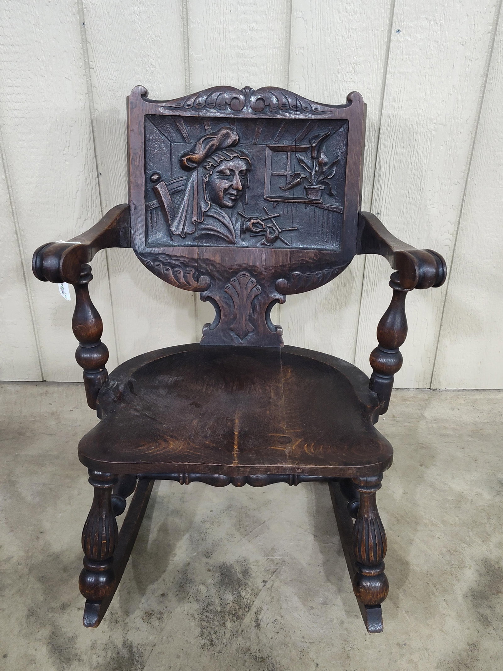 Early Victorian Oak Carved Rocker of Weaving Madam: Another great early piece with highly Carved back depicting a Lady weaving or crocheting. Shows a repair in back and minor separation at glue joints but is very unusual and overall in good solid