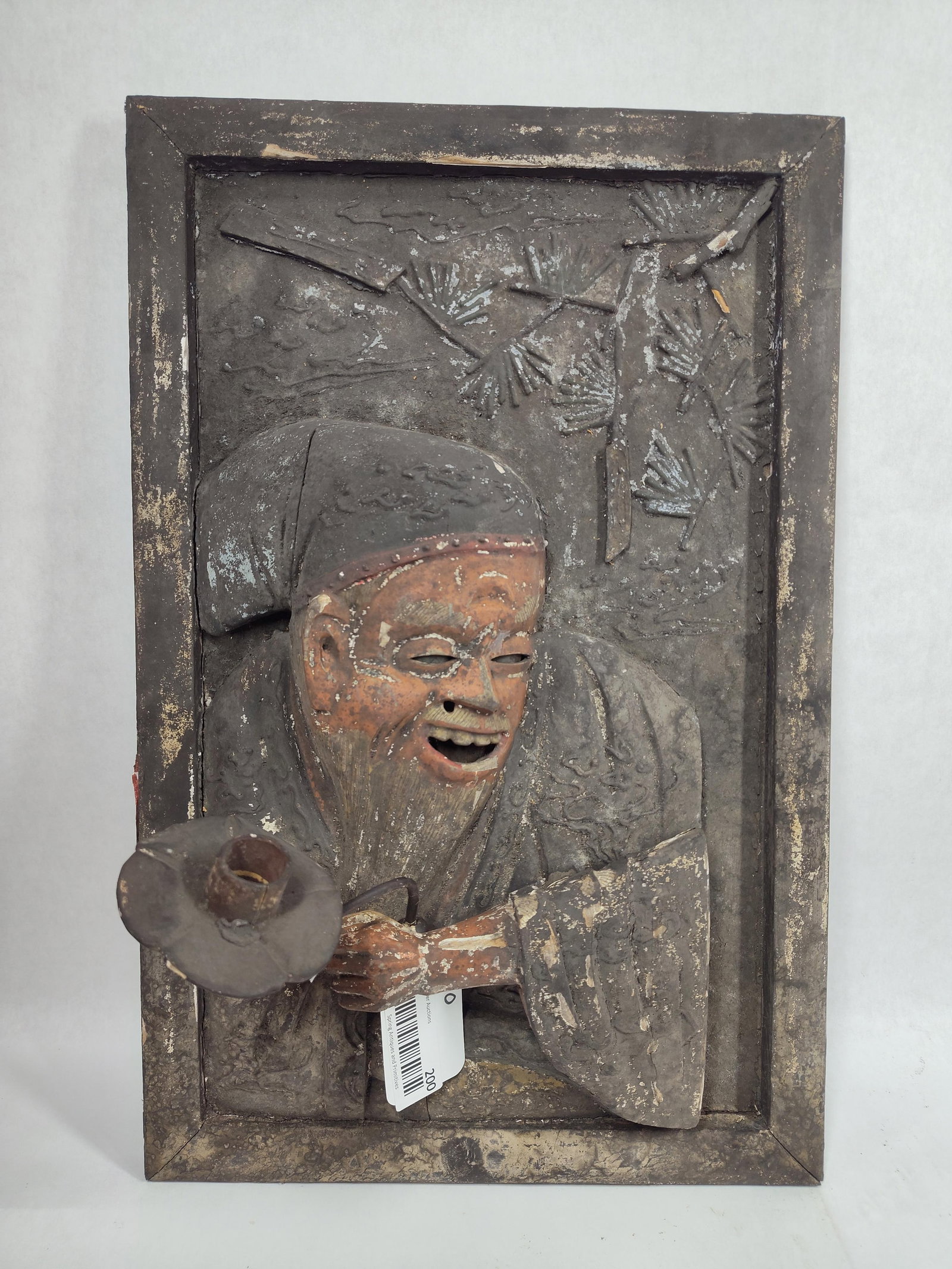 Asian Influenced Framed Wood Carved Wall Sconce: Holding a candle holder in one hand and other arm is hinged. 13in x 20in.