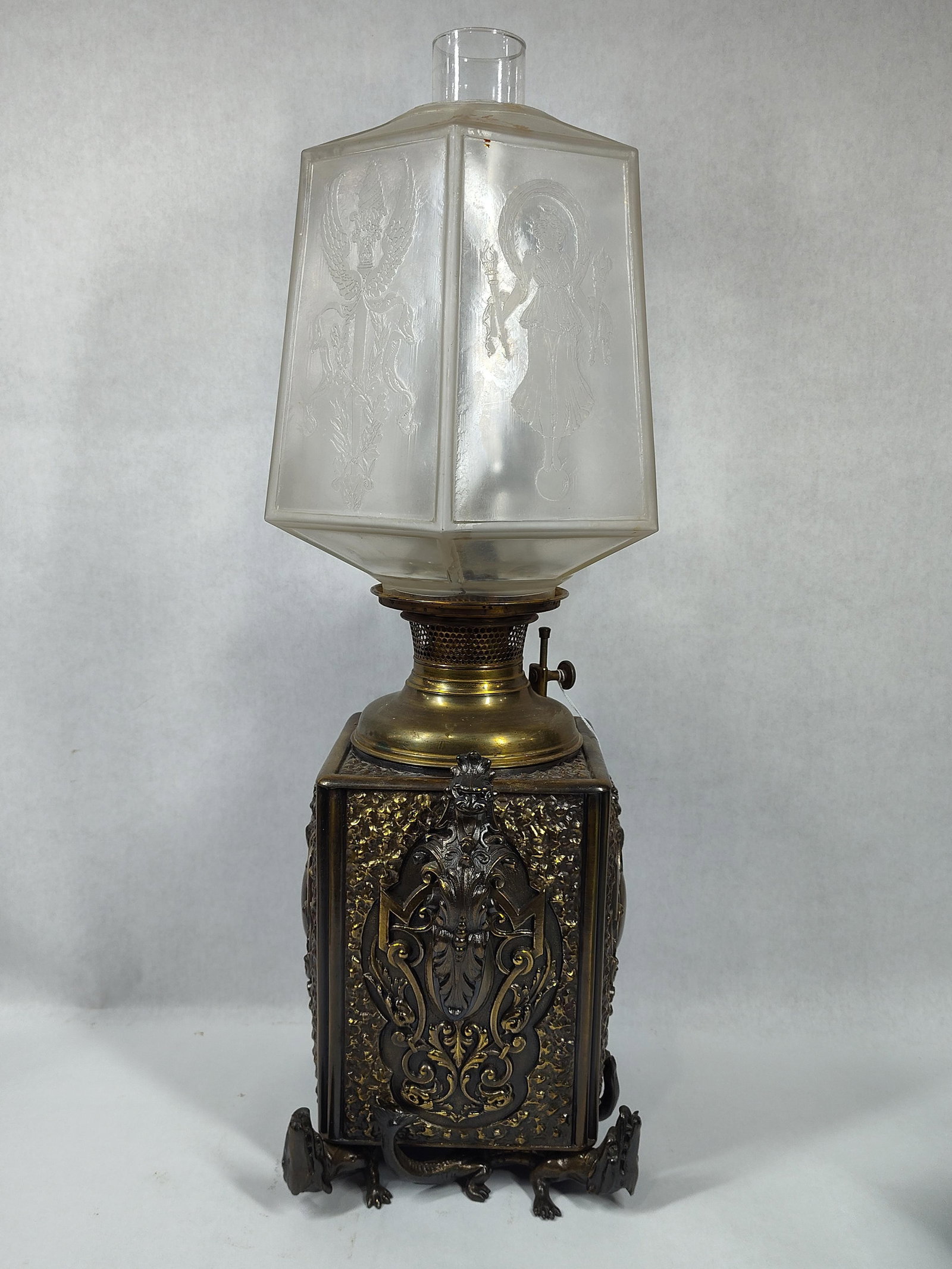 Outstanding Bradley & Hubbard Bronze/Brass Kerosene Lamp: Brass Bradley & Hubbard lamp inset in a beautiful ornate stand with mythical dragon handles and alligator feet, also features a nice frosted glass shade with etched classical figures and motifs!