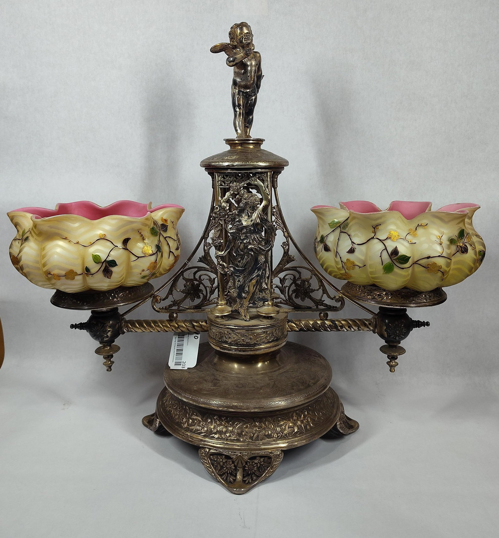 Impressive Ornate 19th c Victorian Bridal Epergne: Beautiful ornate double arm bridal basket with Lady figures on each side and Cherub on top!! Marked Simpson, Hall, Miller & Co. Quadruple plated. Also features 2 Beautiful hand painted satin