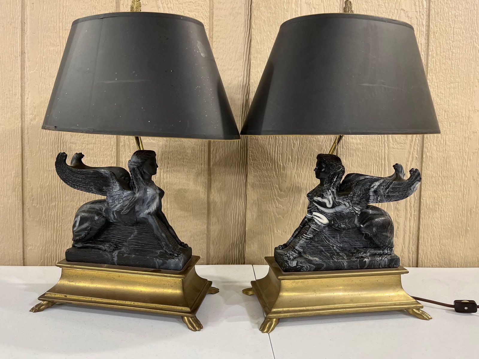 Pair of figural Chapman Lights: Brass bases with claw feet and marble or slate or something similar to that figurals. They have a great look! 20in tall.