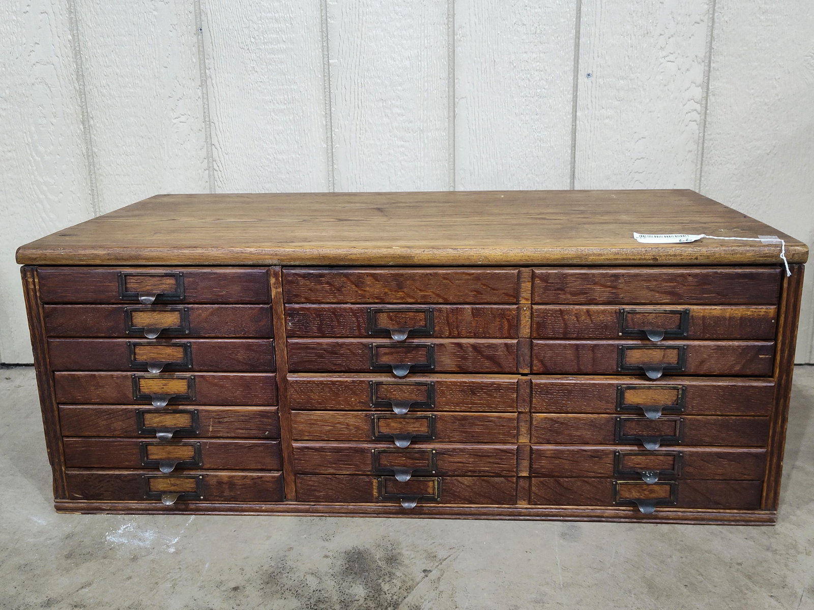 Great Early Tiger Oak 13-drw Cabinet: Left side drawers are as they appear, 2-right side drawers are combined larger drawers with center divider and all drawers with aluminum bottom liners. 33in long 17in wide 12.75in tall.
