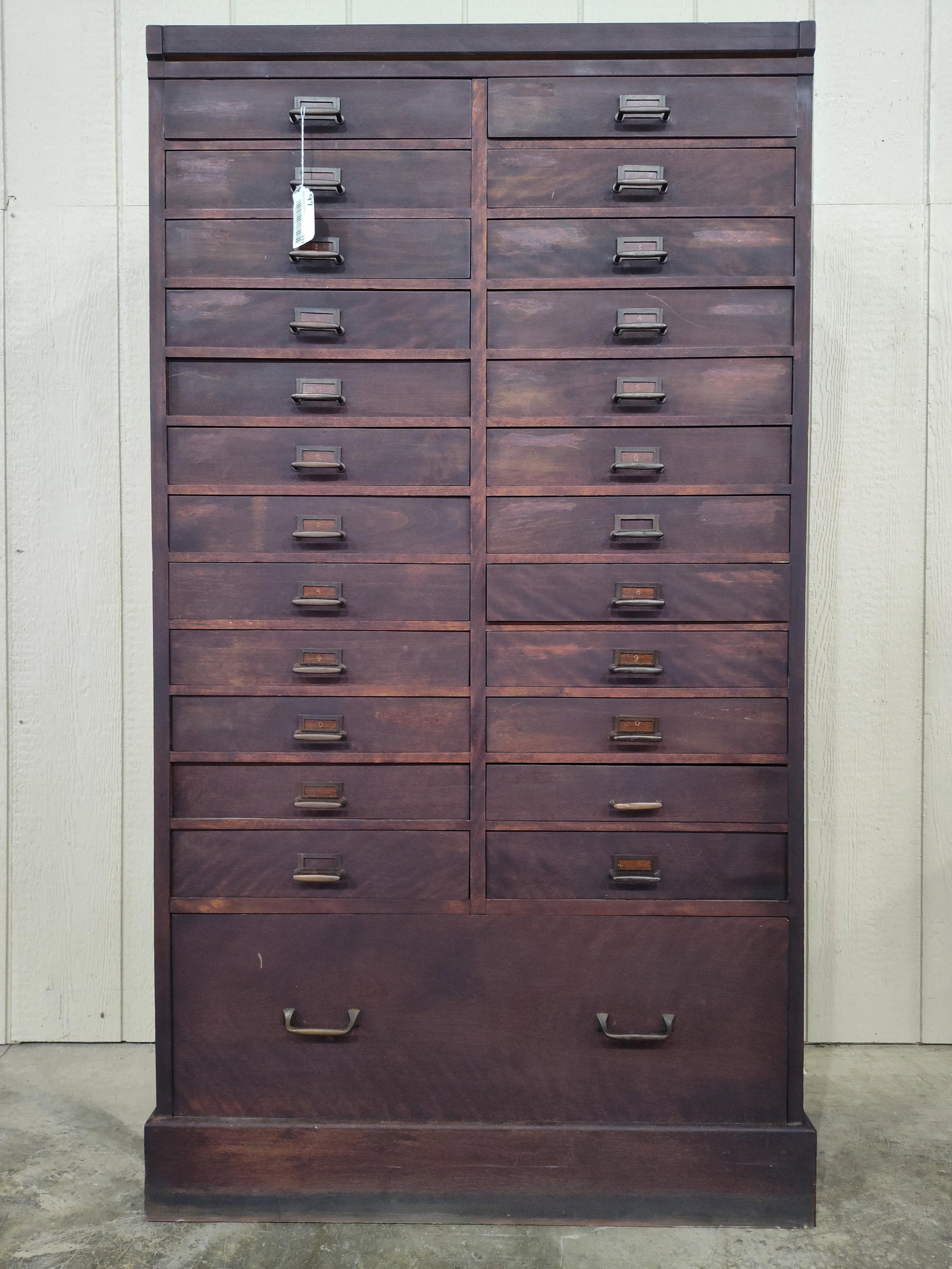 Outstanding 25-drw Industrial Printer's Cabinet: 24 small drawers over 1 large drawer in bottom. Drawers have slots for dividers, but there are no dividers. Nice sleek looking cabinet with brass pulls. 33in wide 17.5in deep 60in tall.