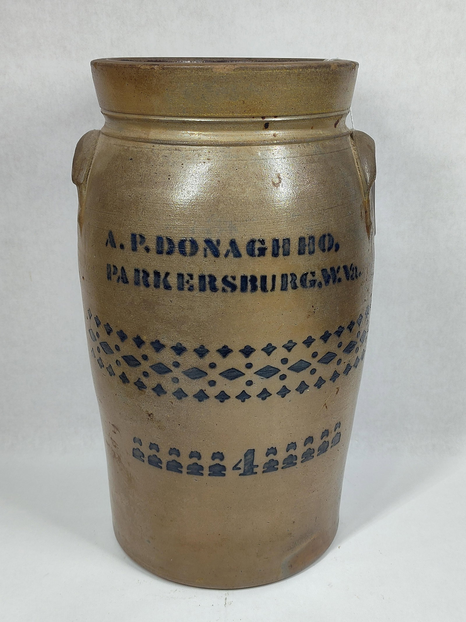 Decorated A.P. Donaghho 4gal churn crock: With a hairline in bottom coming up side and a few flakes on rim. 17in tall.