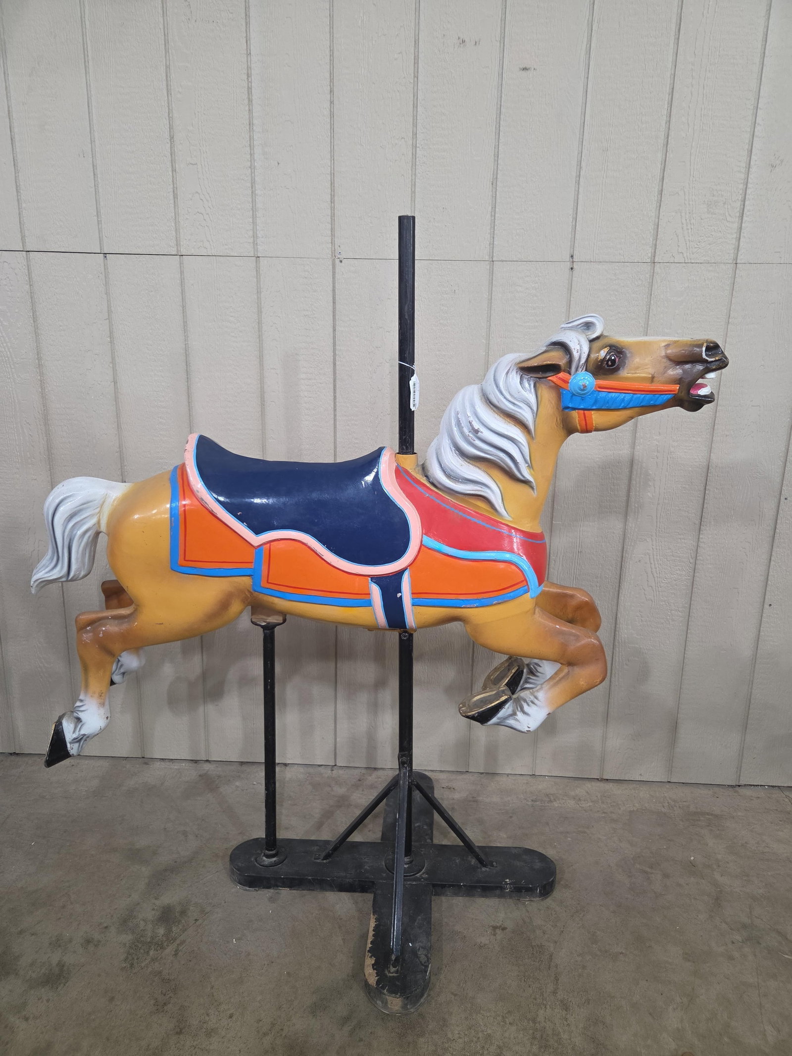 Painted Carousel Horse on stand: Painted metal horse. Approximately 60in long 60in tall to top of pole.
