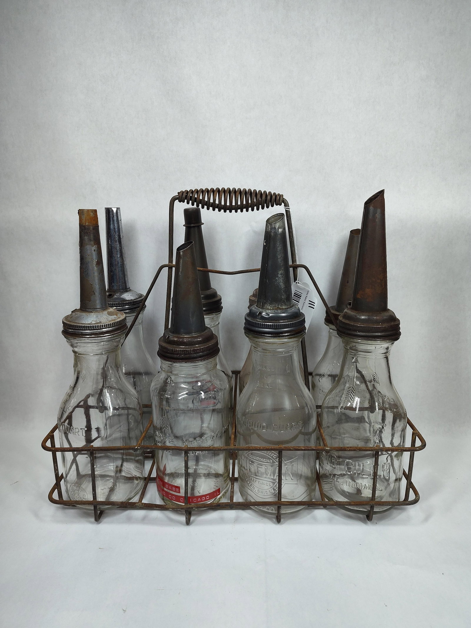 8-Glass Oil Bottles with carrier: 4 are identical bottles, of the 4 there is one with Imperial logo. Other 4 are different, includes a Huffman.