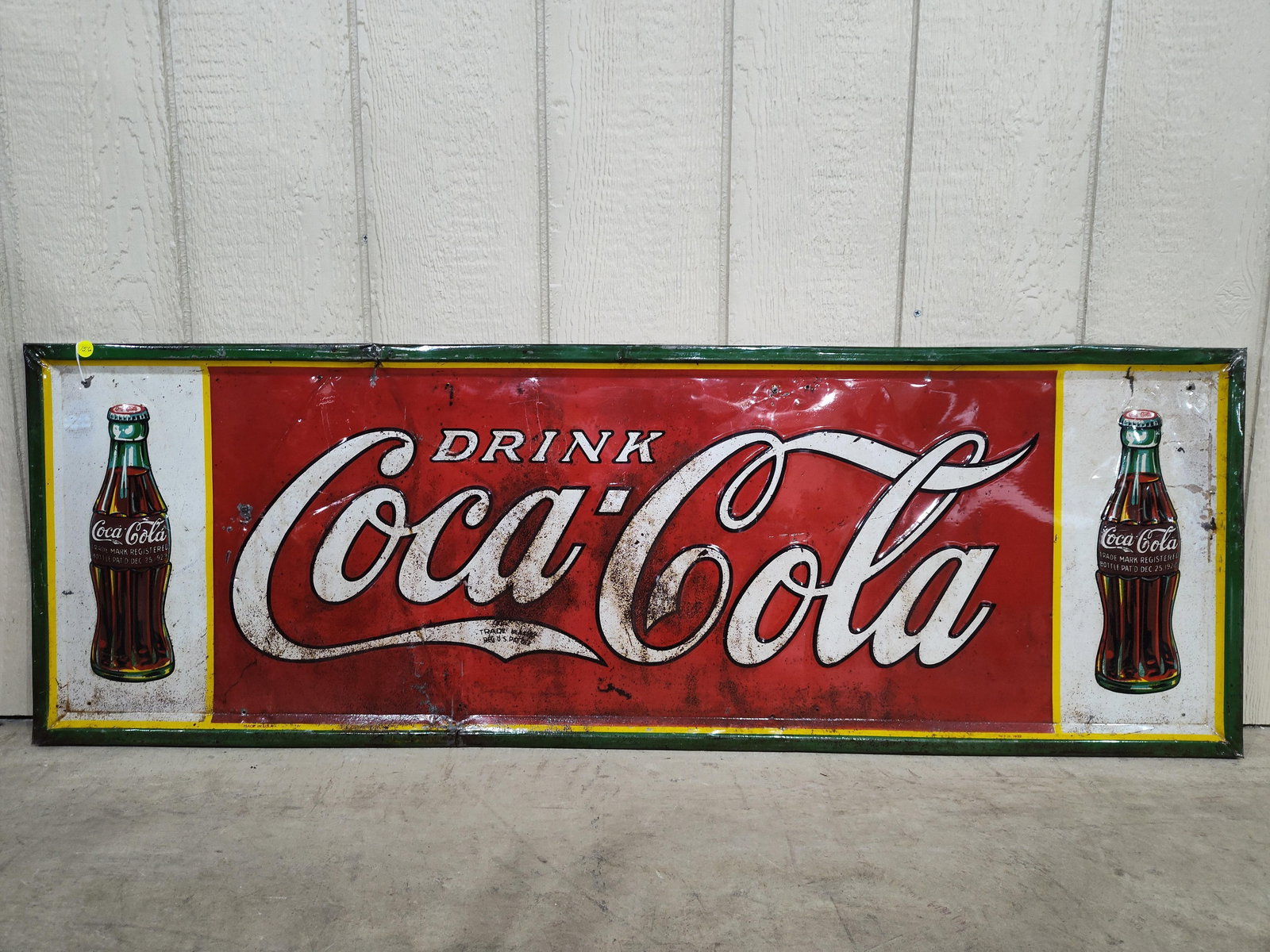 SST 1932 Coca-Cola embossed self-framed sign: 1-sided painted metal self-framed and embossed sign with Xmas bottles on each end. Has been clearcoated to prevent more paint loss. Shows a few wrinkles but presents very well! Marked made in USA 1932