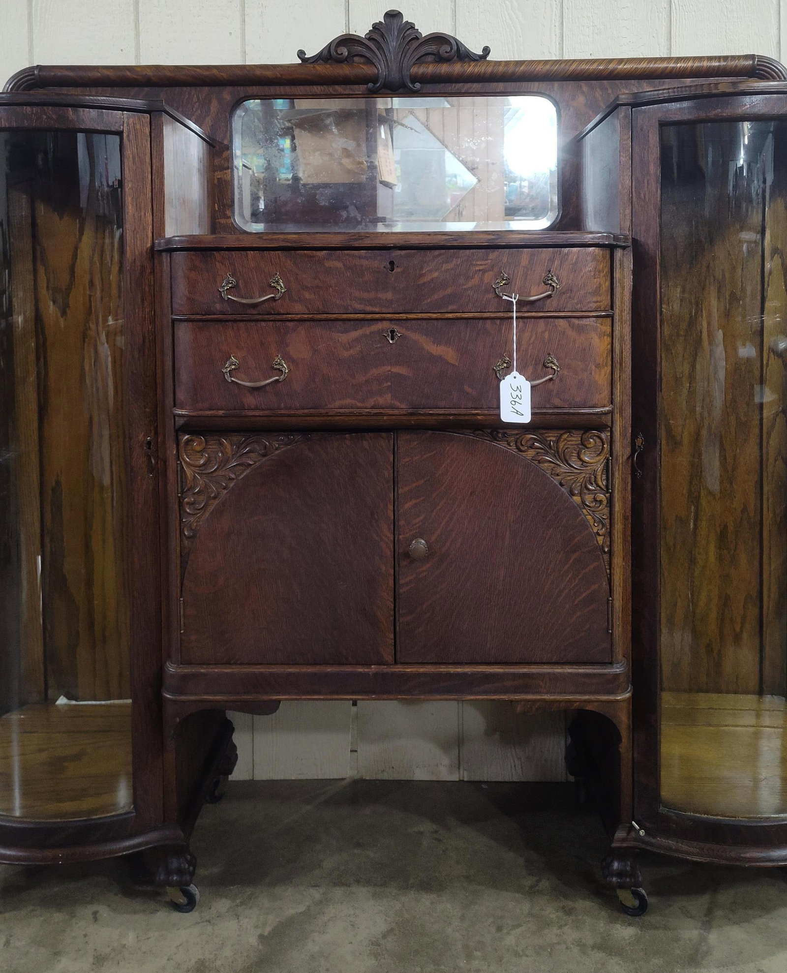 Rare Oak China Buffet Server w/Curved Glass Ends: Beautiful early quartersawn Oak buffet with curved glass curio ends and 2 interior shelves each. Claw feet on casters and in beautiful original condition!! 61.5in wide 18.5in deep 57in tall to crown.