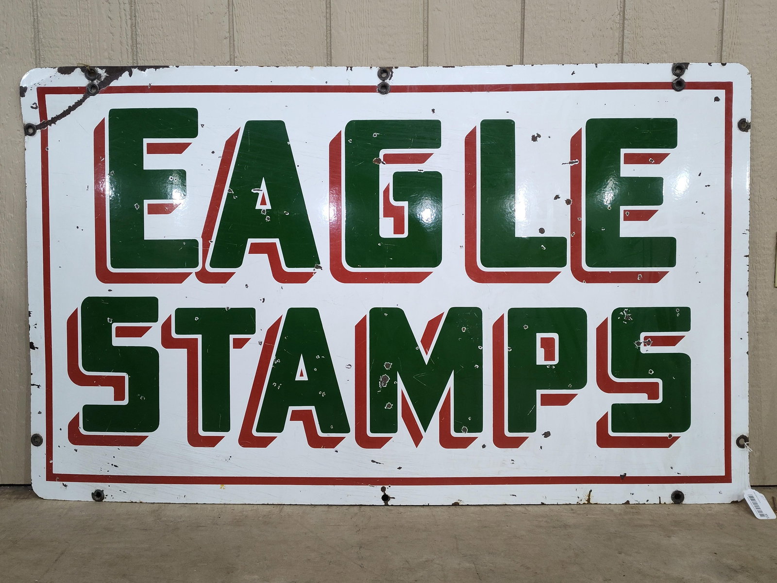 DSP Eagle Stamps sign: 2-sided porcelain with numerous small hits throughout to both sides and some scuffing, one side doesn't have as much scuffing as the other. 36in x 60in.