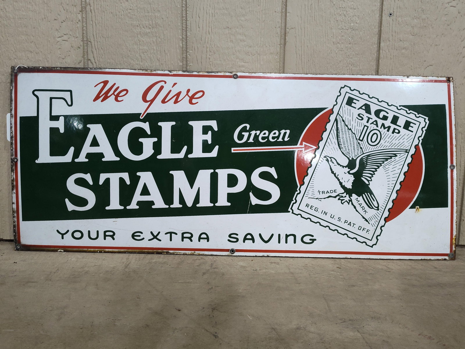 SSP Eagle Stamps with Eagle graphics: 1-sided porcelain sign with some edge wear and some scuffing but overall in pretty good condition! 13in x 36in.