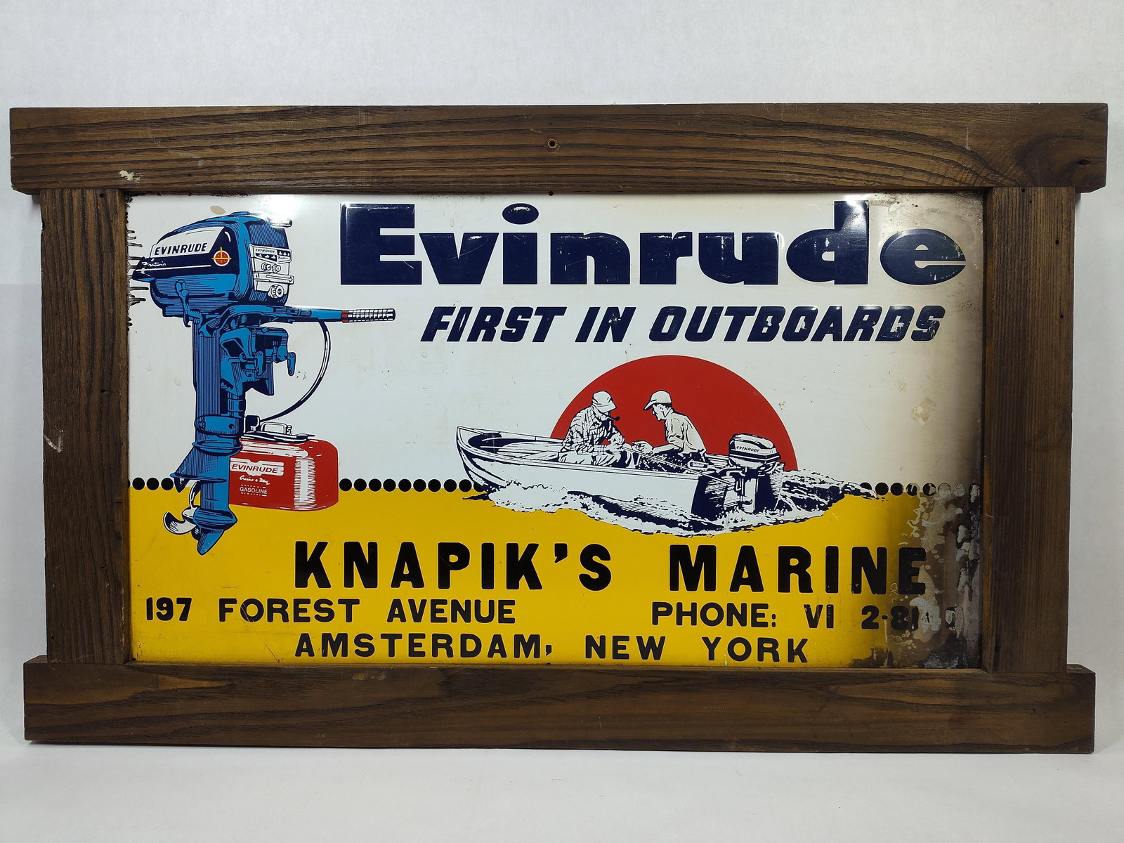 SST Evinrude First In Outboards embossed sign: 1-sided painted metal embossed sign in wood frame. Shows some scuffing, right side appears may have been in a fire and shows some type of runs in upper left side but with outstanding graphics and