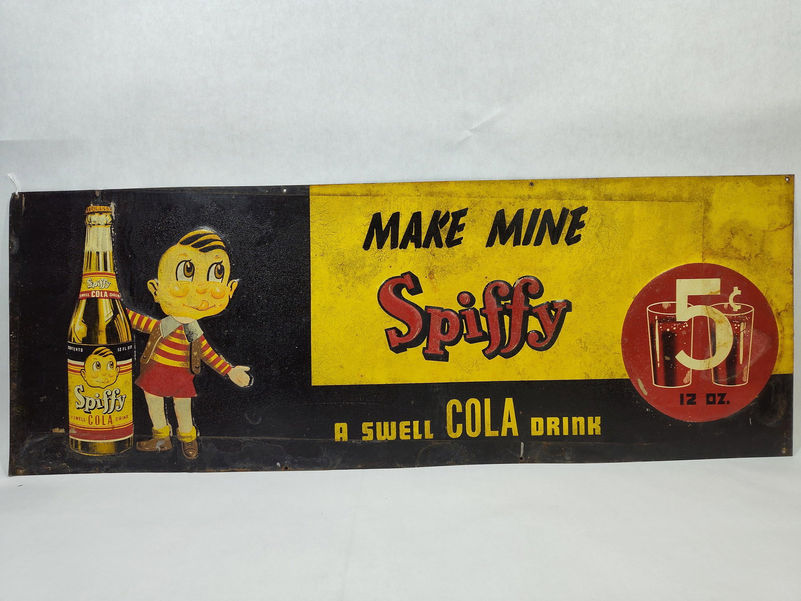 SST Spiffy Cola embossed sign w/ Boy & Bottle: Awesome 1-sided painted tin embossed sign with surface spotting, paint is stable. These were found stacked, hence the marks and spotting. Not one you find everyday! Good colors and graphics!! 11.5in