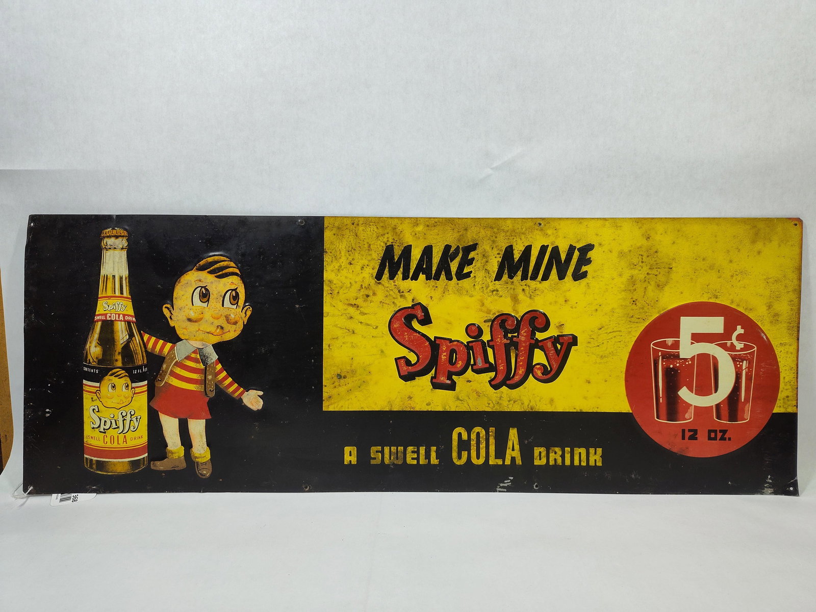 SST Spiffy Cola embossed sign w/ Boy & Bottle: Awesome 1-sided painted tin embossed sign with surface spotting, paint is stable. These were found stacked, hence the marks and spotting. Not one you find everyday! Good colors and graphics!! 11.5in