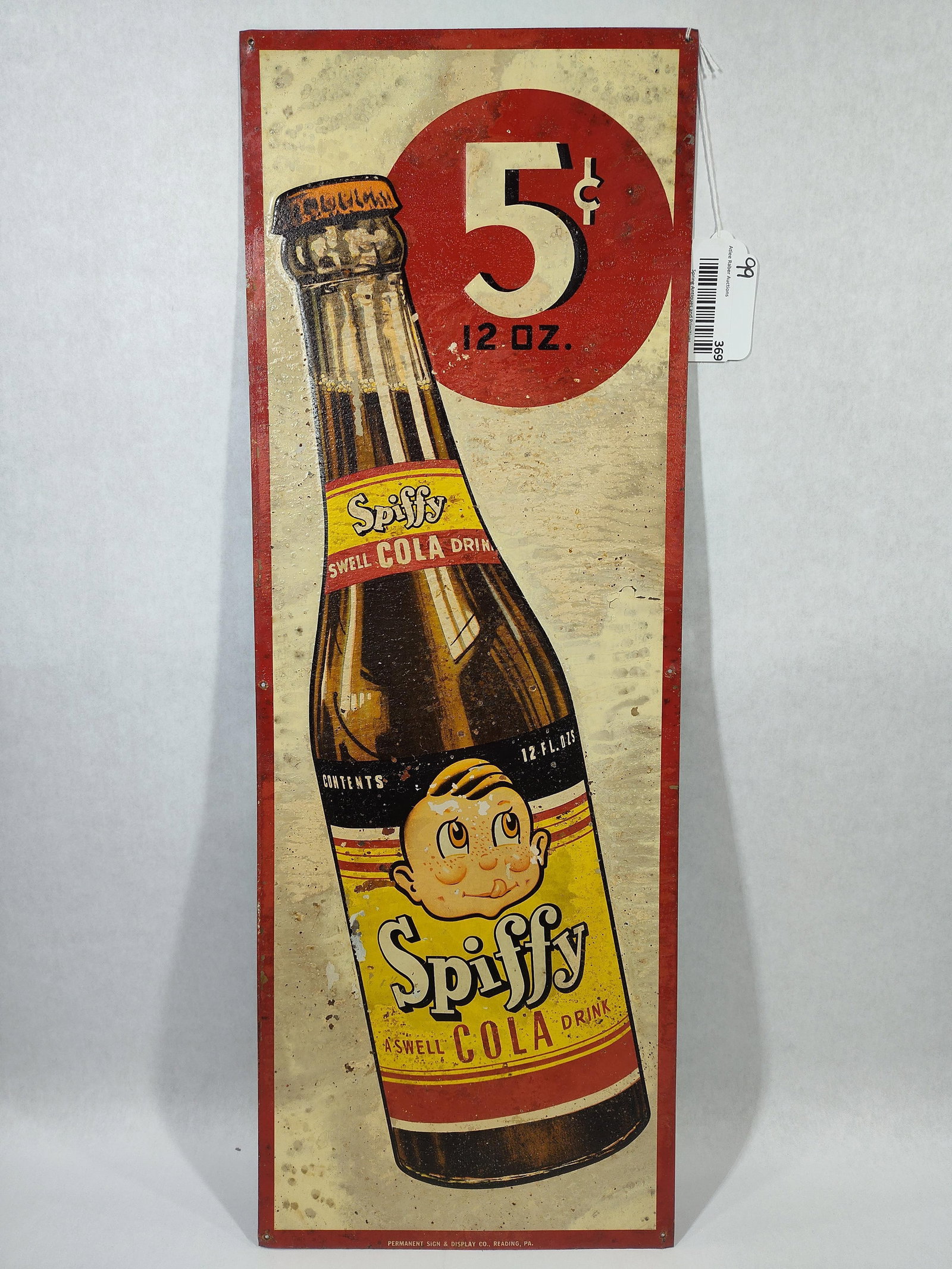 SST Spiffy Cola sign w/embossed bottle: 1-sided painted tin embossed sign with surface spotting, paper marks and a few small spots of peeling but overall paint seems to be stable. Another one you find everyday! Great colors and graphics!