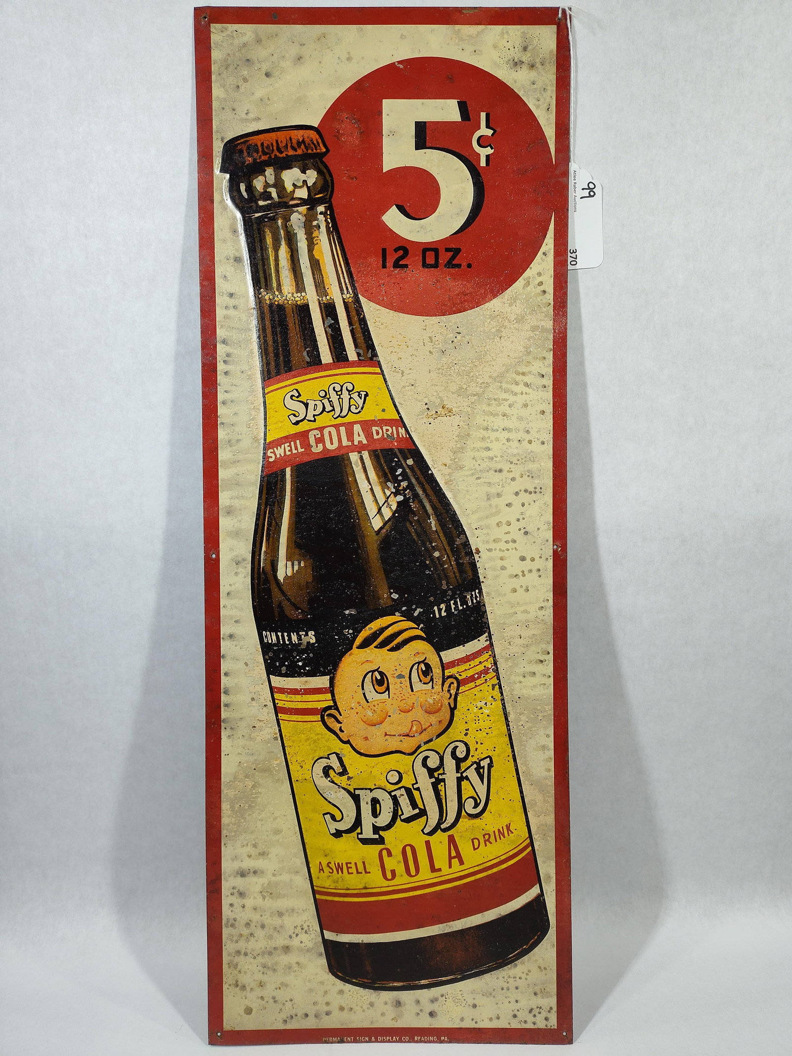 SST Spiffy Cola sign w/embossed bottle: 1-sided painted tin embossed sign with surface spotting, paper marks and a few small spots of peeling but overall paint seems to be stable. Another one you find everyday! Great colors and graphics!