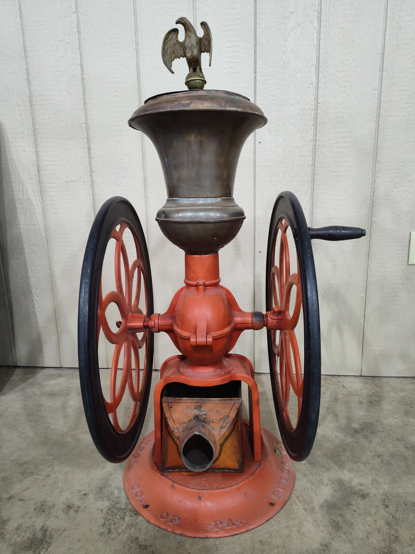 Large Enterprise Double Wheel Coffee Mill: Has an older restoration and is overall in Nice condition! Can in original state and has a homemade brass cover with Eagle finial. 16in wide 43in tall, wheels are 24.5in diameter.