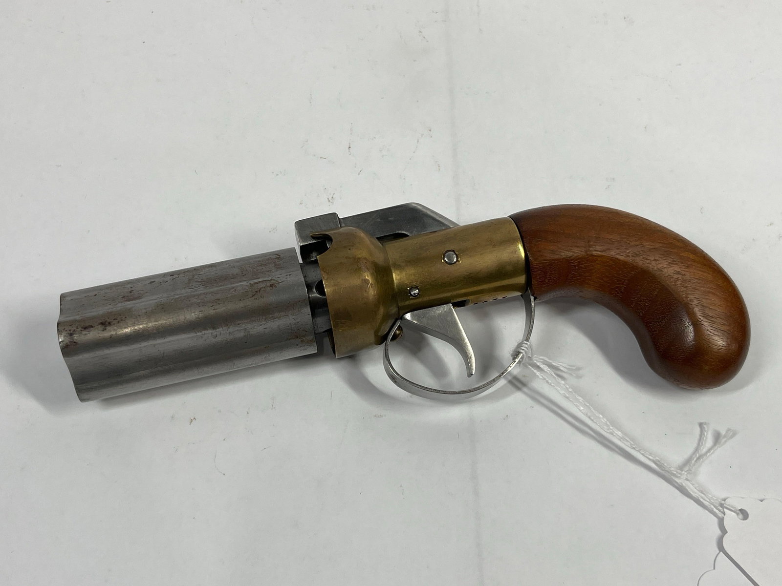 Four Barrel Black Powder Percussion Pistol: Marked 0407 by trigger. Brass body with a wood handle. In very nice condition. 