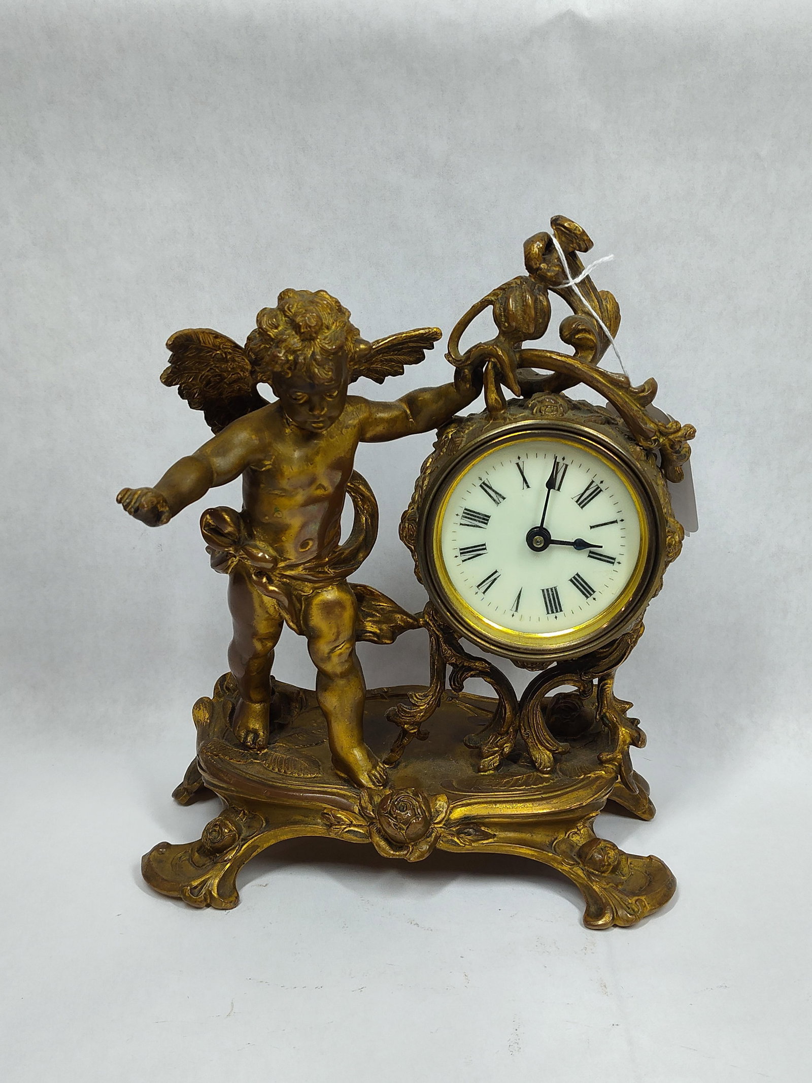 French 19th century Gilded Bronze Cherub Mantle Clock: Beautiful ornate gilded bronze? With Cherub and wind up clock that is in working condition! 9in wide 10in tall.
