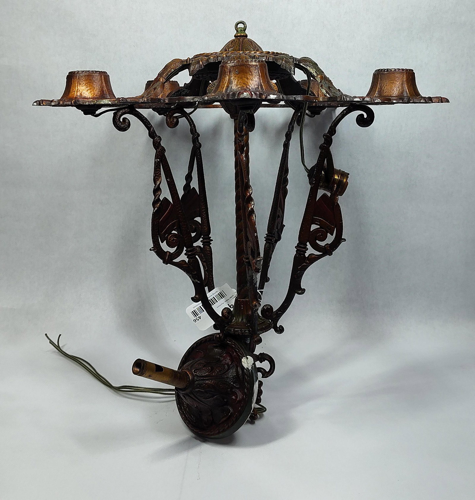 Pair of Highly Ornate Cast Metal Chandeliers: Patterns on both are matching, diameter is the same but one is approximately 3in higher. All sockets are in place and wired. Approximately 19in diameter 18in and 21in tall.