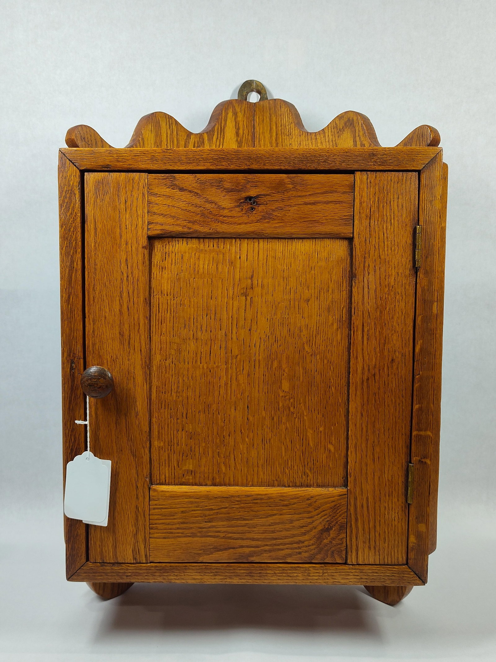 Small Oak Hanging Corner Cabinet: Features 1 fixed interior shelf and also has hanging bracket on back. Nice clean cabinet! 16in wide 24in tall 11in deep.