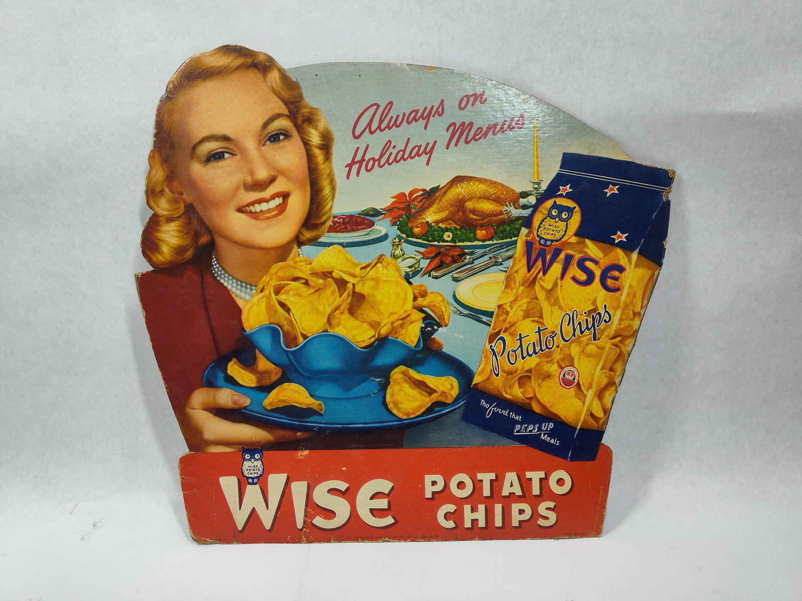 Great Graphical 1949 Wise Potato Chips cdbd easelback sign: Nice graphical die cut cardboard easelback sign with some edge wear but with great colors and graphics!! 14.25in x 15in.