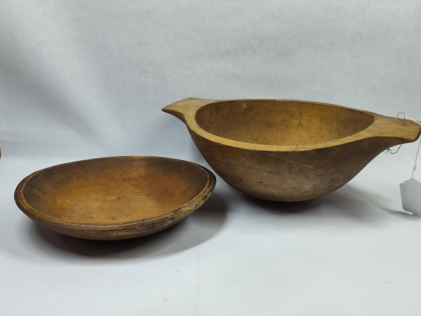 Trencher Style and Small Round Wooden Bowls: Unusual round trencher Style bowl with a small crack on rim, 12in diameter, and small 10.5in bowl.