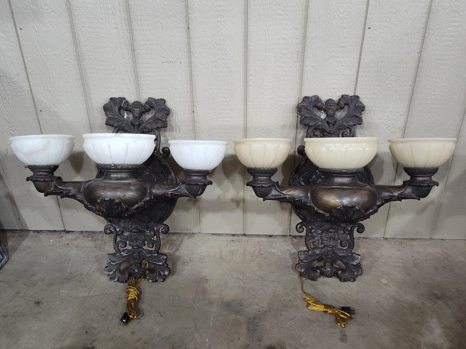 Pair of Impressive Victorian Style Dual Arm Wall Sconces: Beautiful ornate dual armed sconces with Alabaster shades and bronze finish. Sconces are matching, 1 set of shades is white, while other is more tan or off white. Both are wired and in excellent