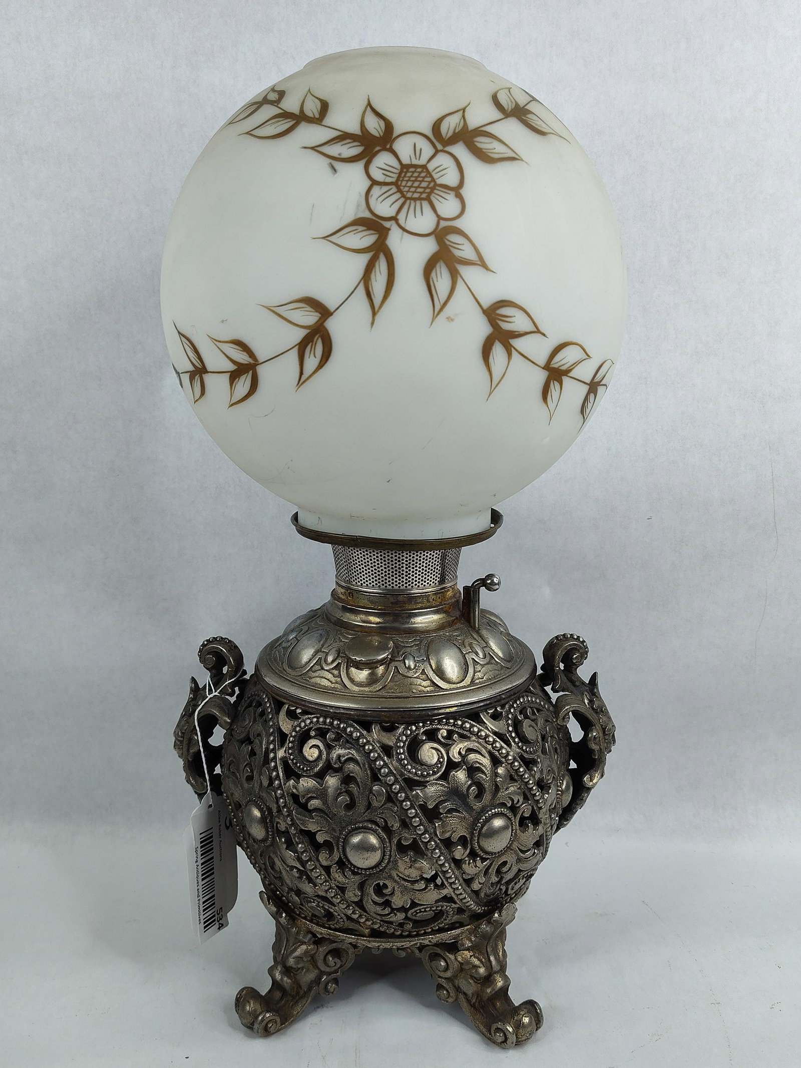 Bradley & Hubbard Banquet/Parlor Kerosene Lamp: Highly ornate lamp with North Wind face figural handles and feet. 19in tall.