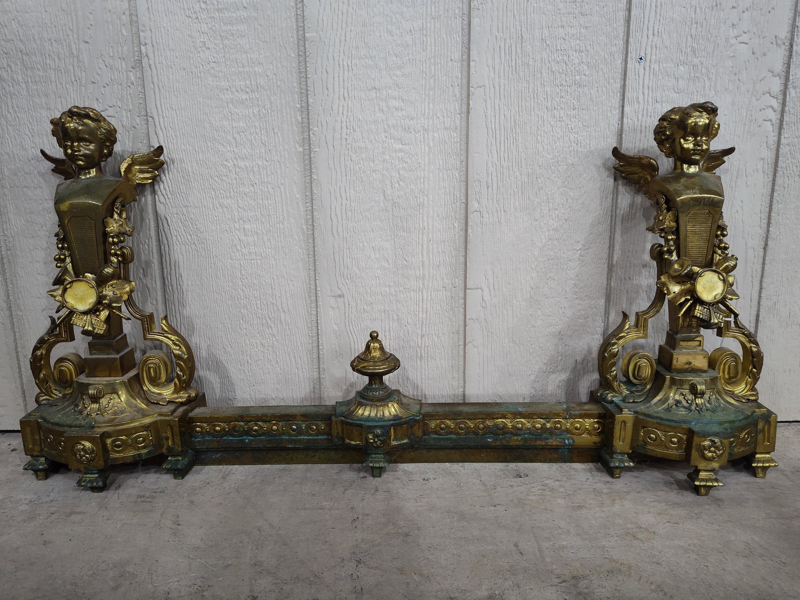 19th C. French Louis XV Style Cherub Fireplace Fender: Ornate gilted piece showing some oxidation but should clean up. 36in long 17.5in tall.