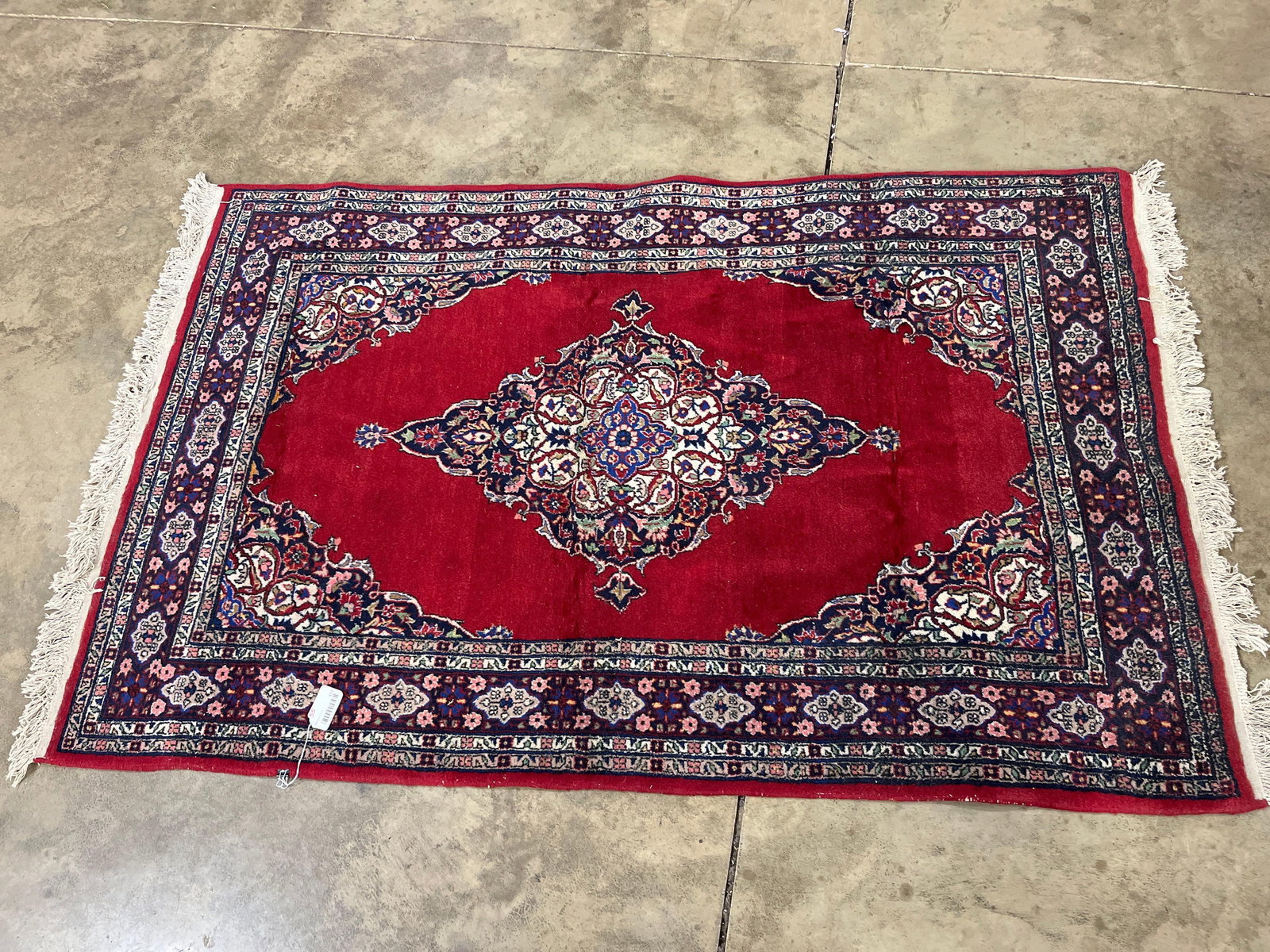 Genuine Persian Wool Rug: Traditional red field with intricate medallion and floral motifs. 77x49