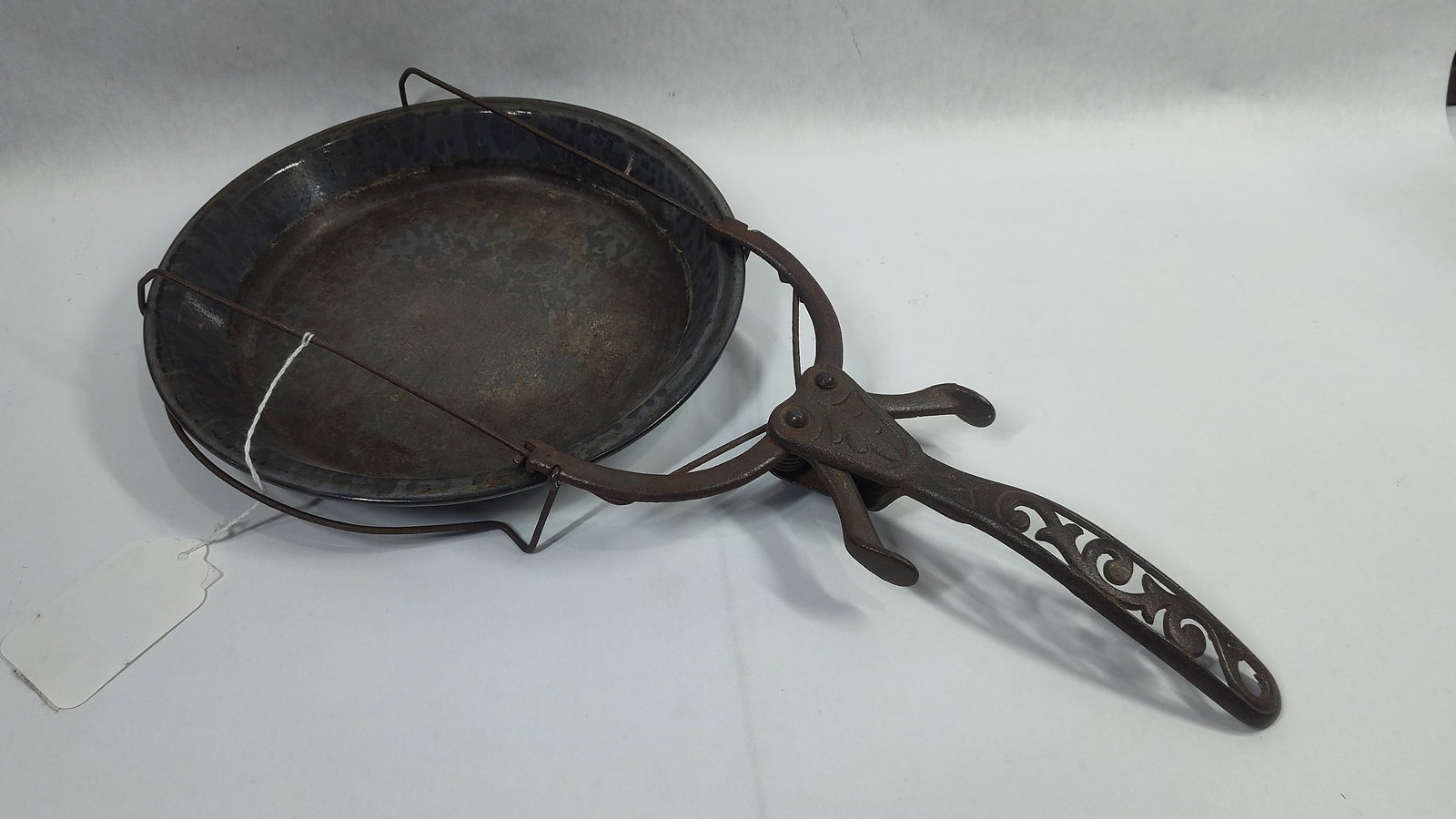 Ornate Cast Iron Bug Shaped Pie Pan Carrier: Unusual ornate cast iron carrier with 2 handles for mechanical wire arms that fit around pan to lift them out of oven or fireplace. Overall length is 17.5in.
