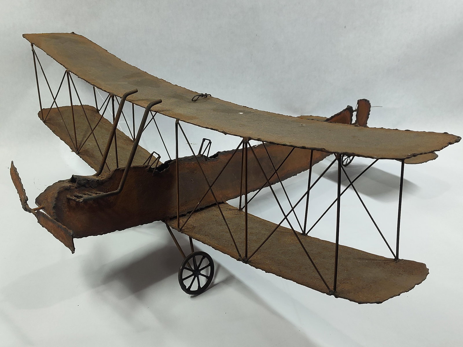 WW II Metal Art Works Hand Crafted Bi-Plane Sculpture: Showing areas of wear due to age and display measuring 24 x 27