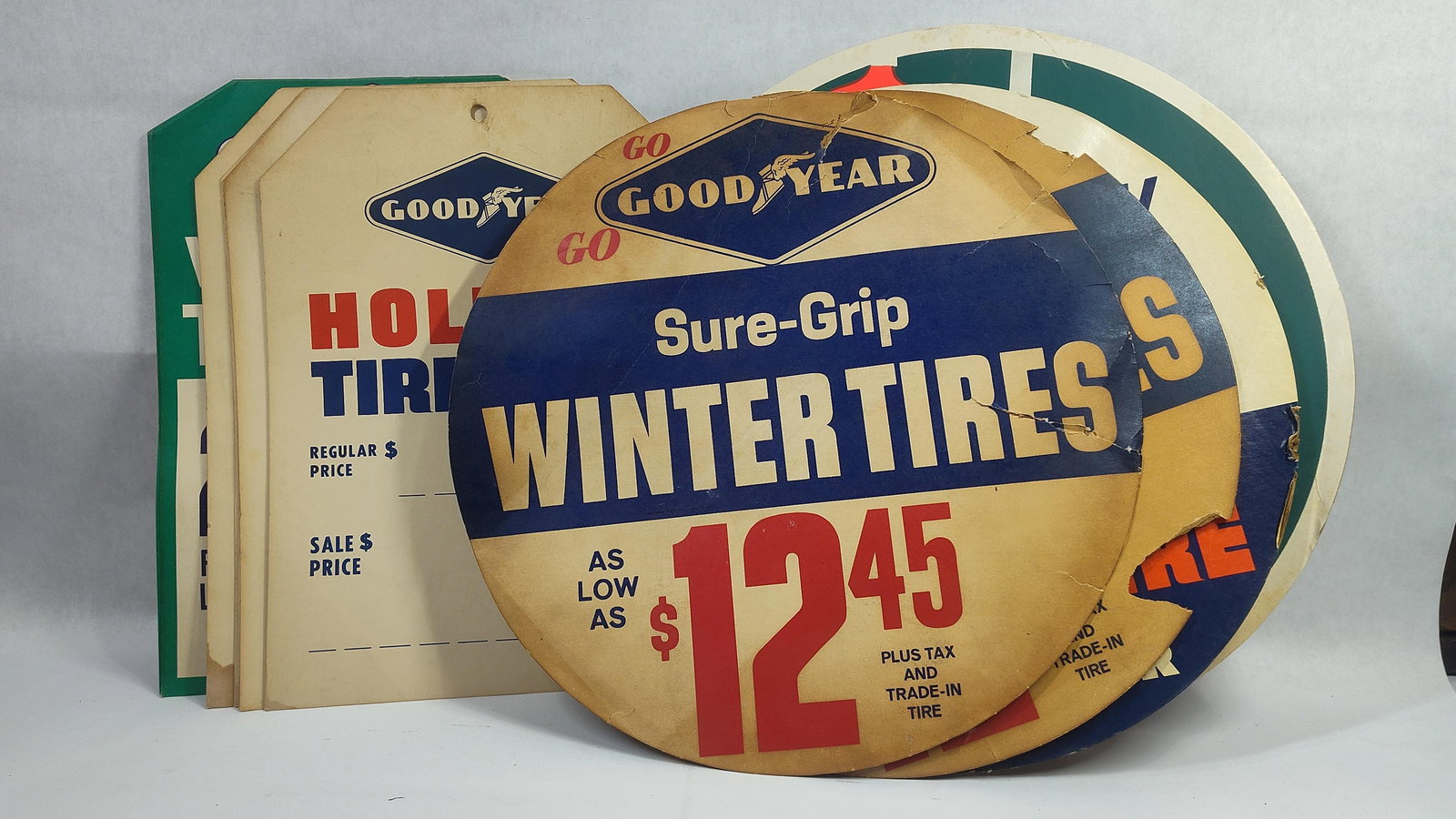 Goodyear Tire Inserts and Sale Tags: Includes 4 inserts, 15in diameter, shows condition, and 8 new old stock sale tags, 10in x 14in.