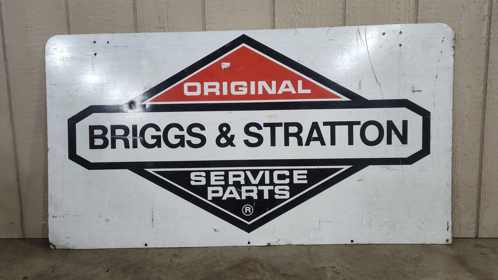 DST Briggs & Stratton sign: 2-sided painted metal sign with scuffing. 25.5in x 47.5in.
