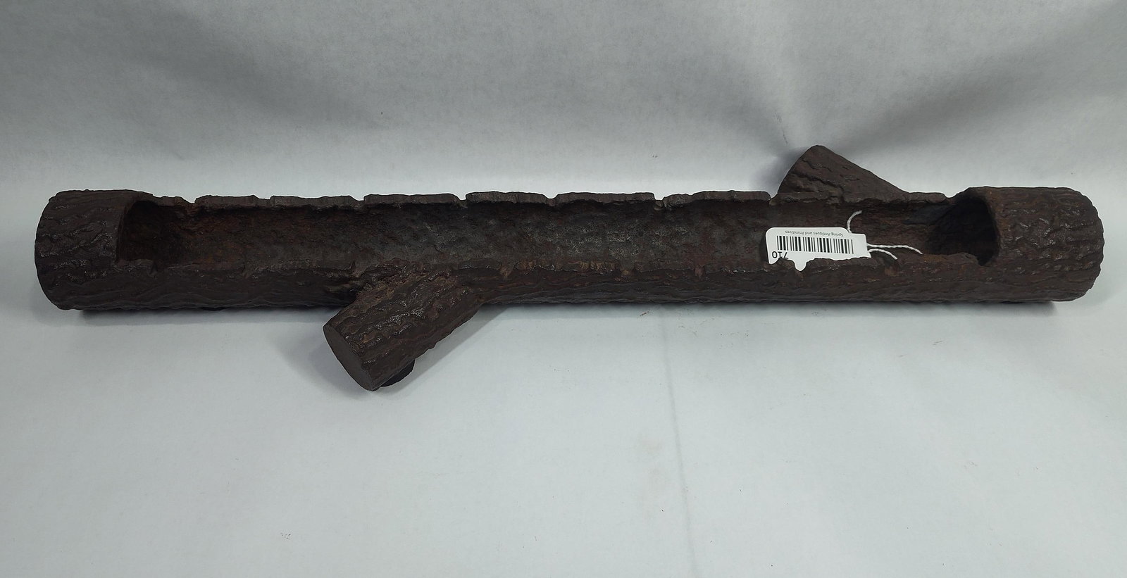 Cast Iron Log Vessel: A heavy cast iron piece with a 2 inch deep vessel. Slots run along the sides but unsure what they may be for. Items like these have been found and used as planters. 25.5 inches long