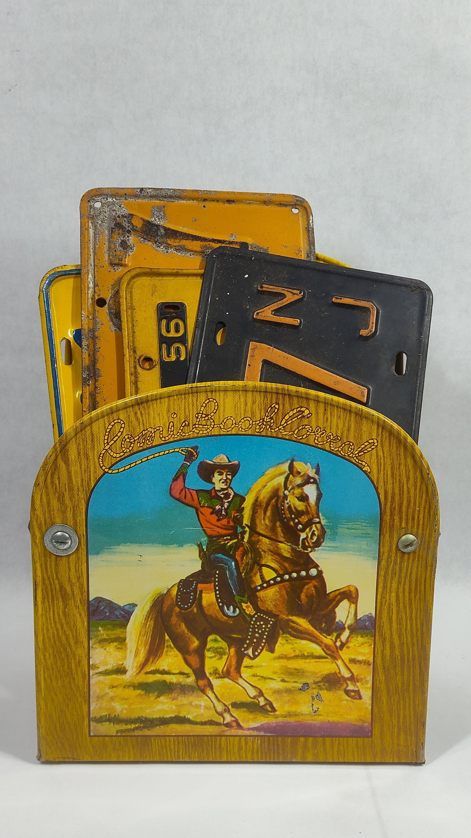 4-Metal License Plates & Roy Rogers Comic Book Corral: Tin Litho comic book holder and 4 metal embossed plates, includes an early NJ, 1930 & 56 California and 1960 OH.