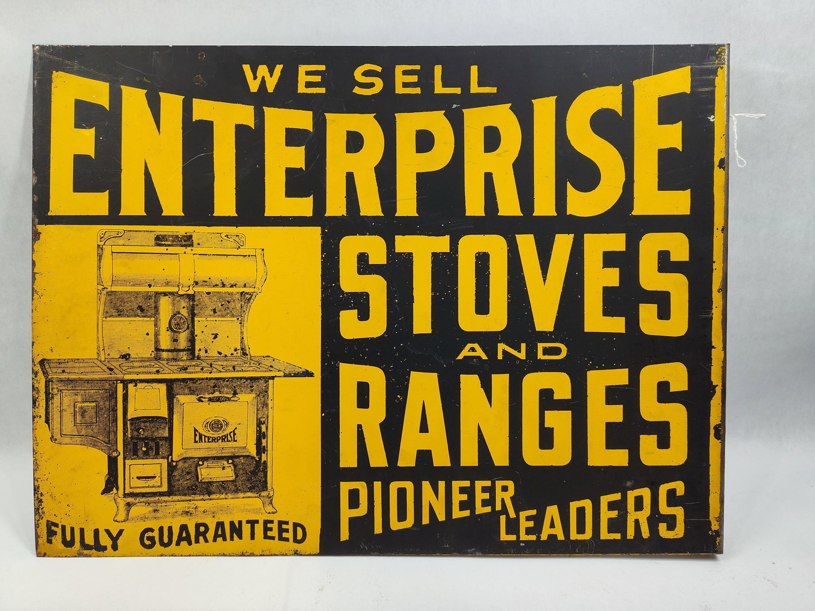 Enterprise Stoves and Ranges Double Sided Metal Flange Advertising Sign: Adouble sided painted metal flange advertising sign for Enterprise Stoves and Ranges. The sign features a high contrast yellow and black color scheme. The composition includes bold block lettering and