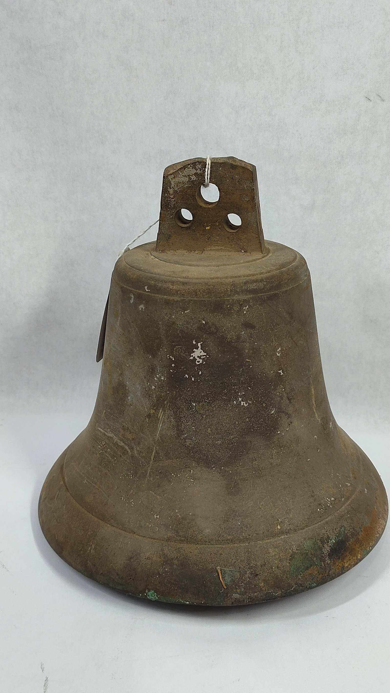 Antique Cast Copper Alloy Bell with Iron Clapper: This antique bell is constructed of cast copper alloy, likely bronze or brass, and is characteristic of farm or schoolhouse bells from the 19th or early 20th century. The bell features a flared body