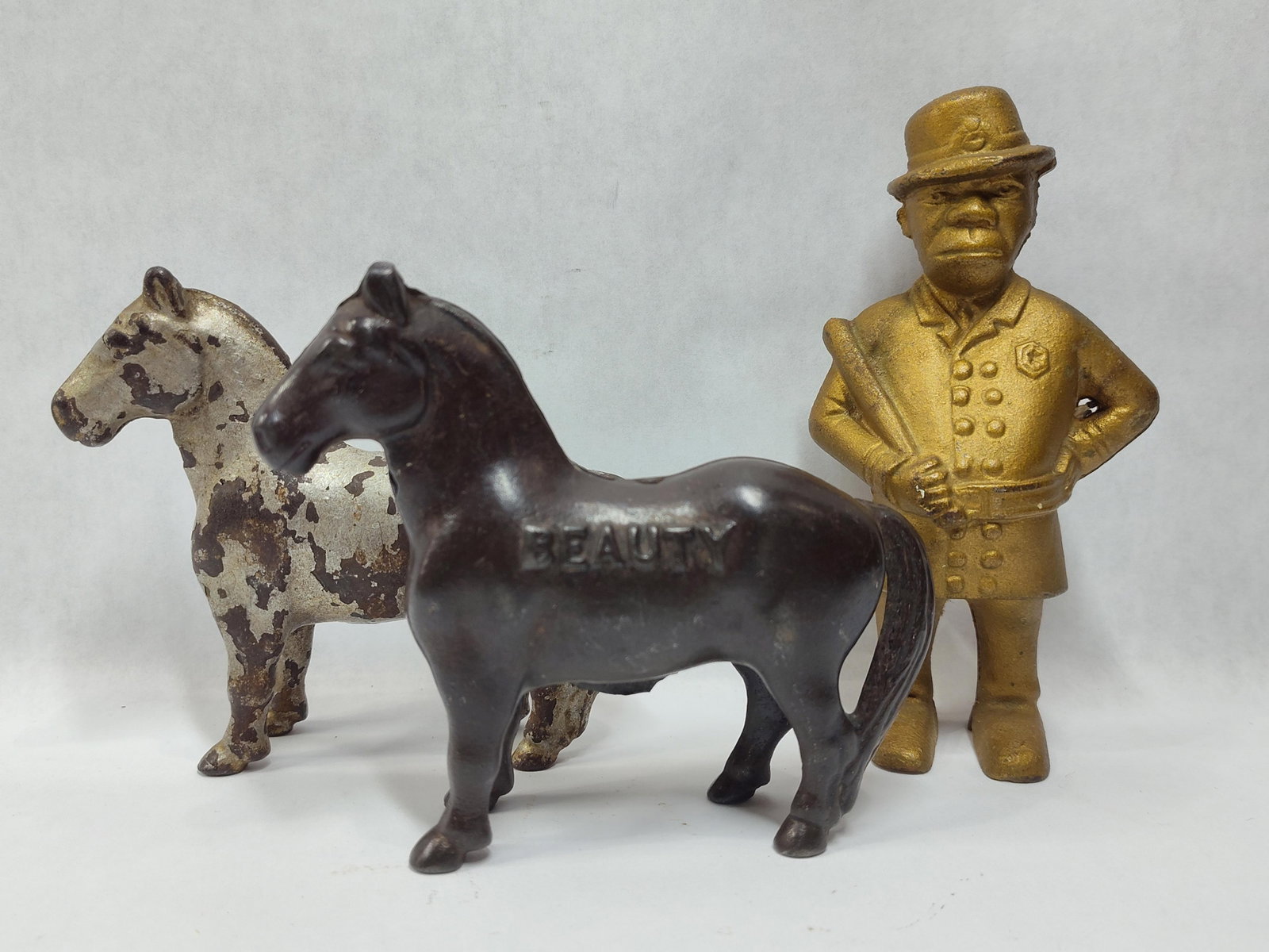 A Trio of Antique Cast Iron Still Banks Including Two Horses and a Policeman (1 of 7)