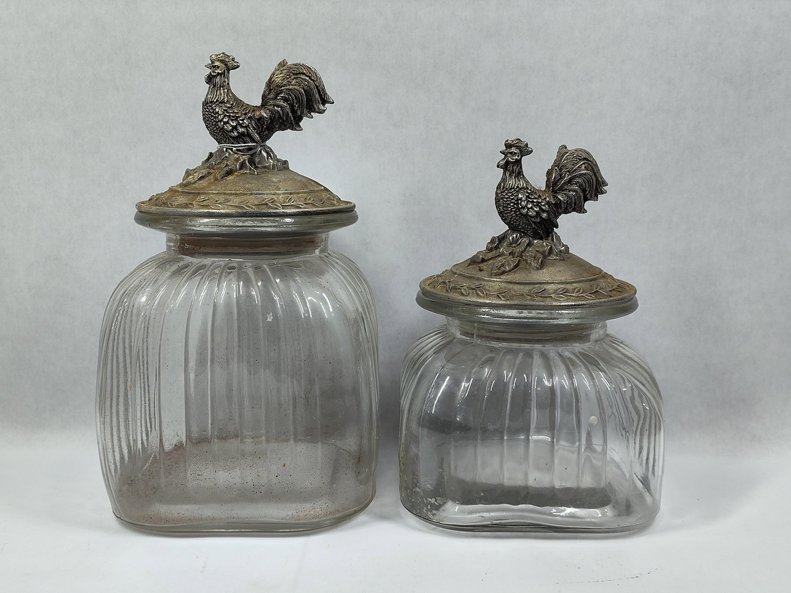 A Pair ofFluted Glass Canisters with Rooster Finial Metal Lids (1 of 4)