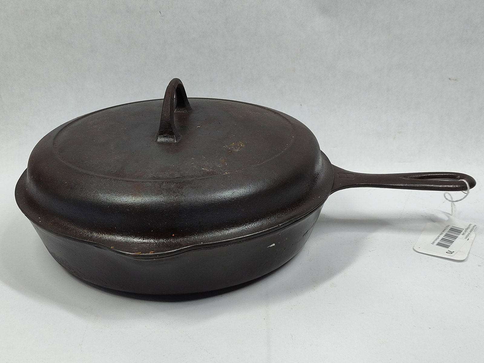 Griswold No. 8 Cast Iron Skillet with Matching Self-Basting Lid: AAmerican-made cast iron skillet set manufactured by Griswold in Erie, Pennsylvania. The set consists of a number 8 skillet and a matching self-basting lid. Both pieces are sand-cast and feature the