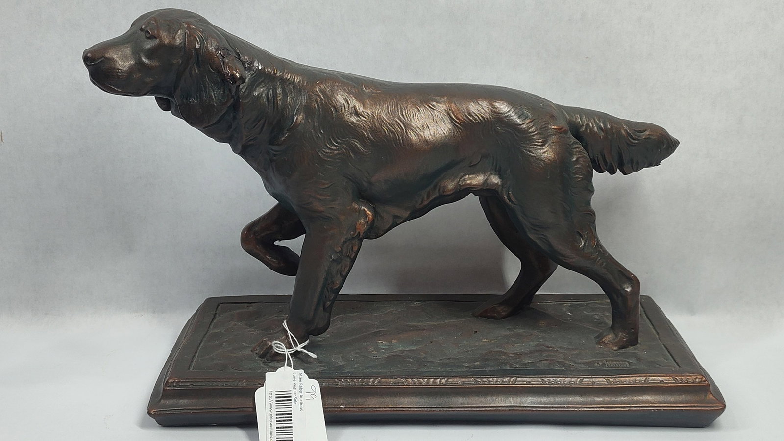 Austin Sculpture Composite Setter Dog on Point with Faux-Bronze Finish: This decorative sculpture, produced by Austin Productions Inc., depicts a setter hunting dog in a classic pointing stance with one front paw elevated. The piece is modeled in the 20th-century